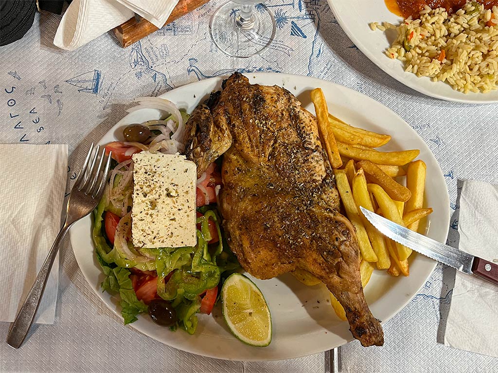 Cooked meal made from diced meat, carrots green and red peppers, served with mixed salad, rice and fries.